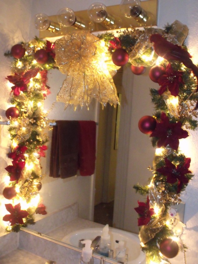 Lavish Christmas Bathroom Decorations with Decorative Xmas Ornaments like Red Poinsettia Red Baubles Gold Bow Ribbon and LED Lighted Garland for Small Frameless Vanity Mirror 634x845 20 Amazing Christmas Bathroom Decoration Ideas